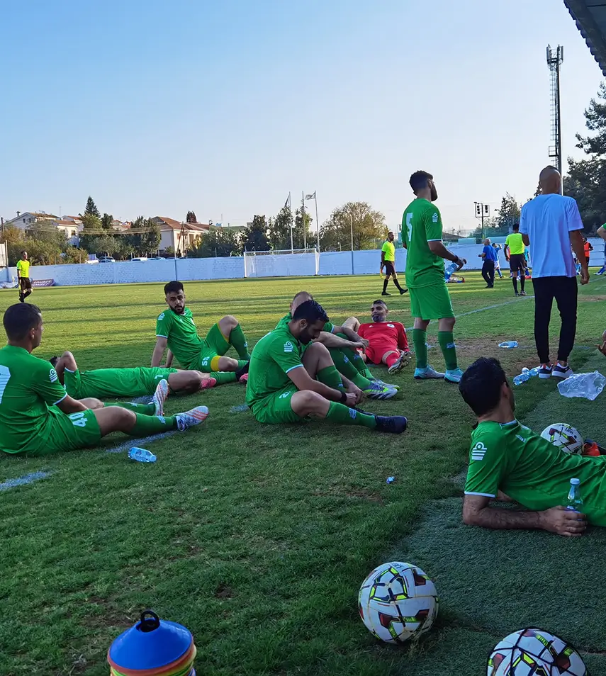 The team together after the game sitting in the field